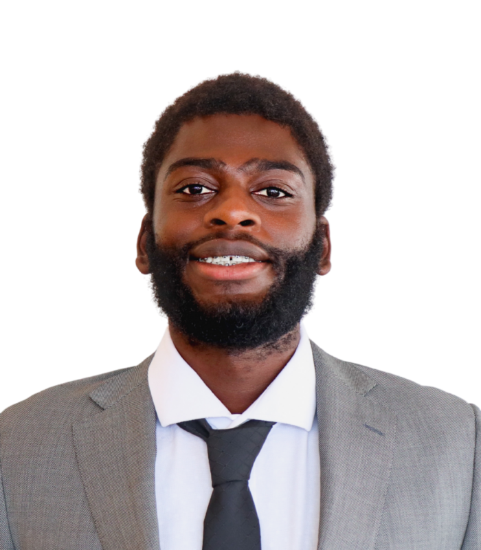 Meet Our Team - Professional and Welcoming Group at a Conference Table Faces the Camera, Team Leader Sitting on the Table with Arms Folded